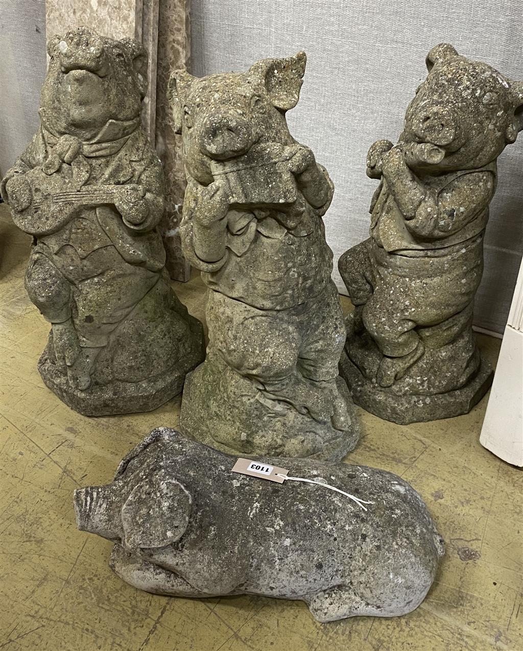 Four reconstituted stone garden ornaments, modelled as pigs, largest 60cm high